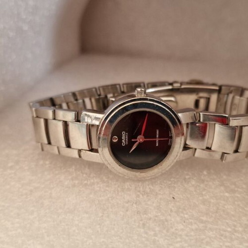 Casio women's watch used with black dial and metal bracelet