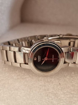 Casio women's watch used with black dial and metal bracelet