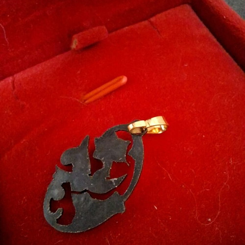 Gold pendant with bird and flowers like new