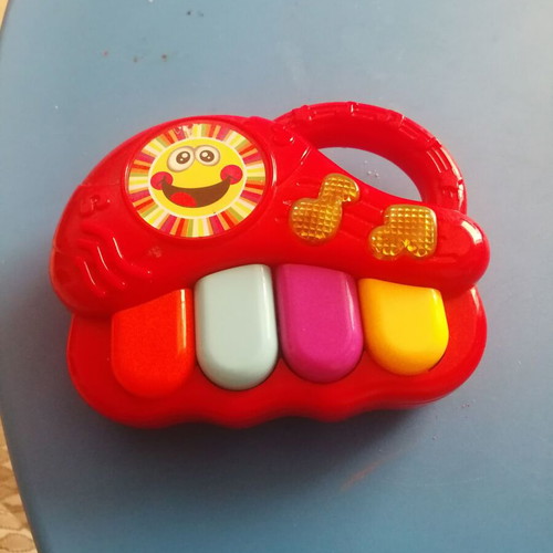 Red baby musical piano toy with four colorful keys
