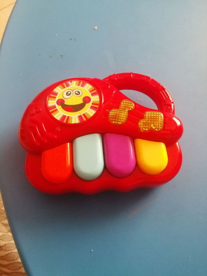 Red baby musical piano toy with four colorful keys