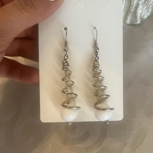 Silver dangling earrings with spiral design and white sphere