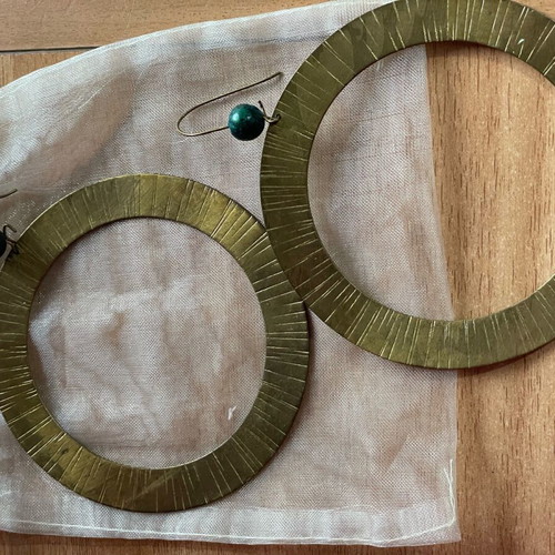 Handmade earrings used, round flat with green bead decoration
