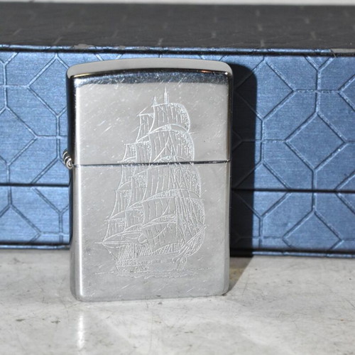 Zippo chrome lighter with sailboat design used