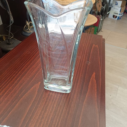 Glass decorative vase with modern wavy design, used