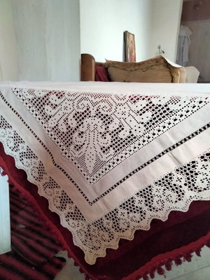Handmade beige tablecloth with knitted corners and lace