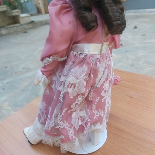 Porcelain doll new with stand for support