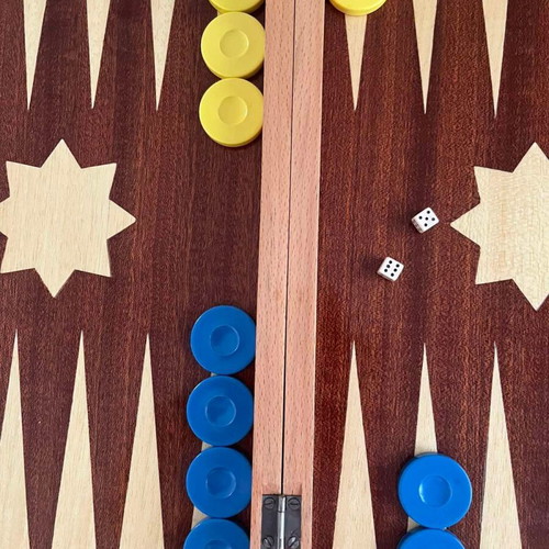Wooden backgammon set used with colorful checkers and dice