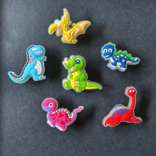 Crocs charms set with fluorescent dinosaurs like new