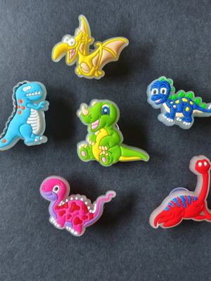 Crocs charms set with fluorescent dinosaurs like new