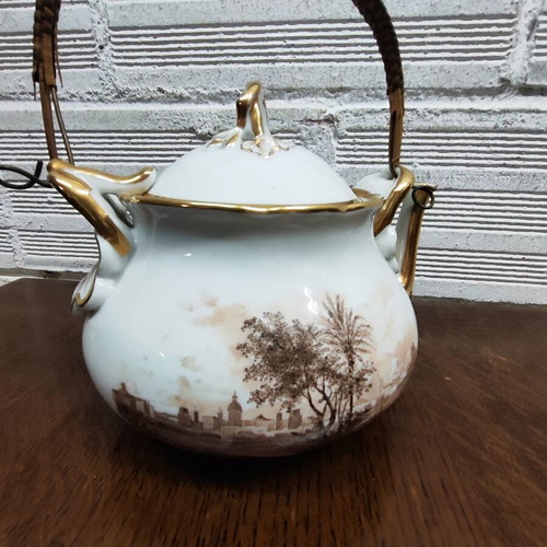 Antique porcelain teapot with wooden handle used