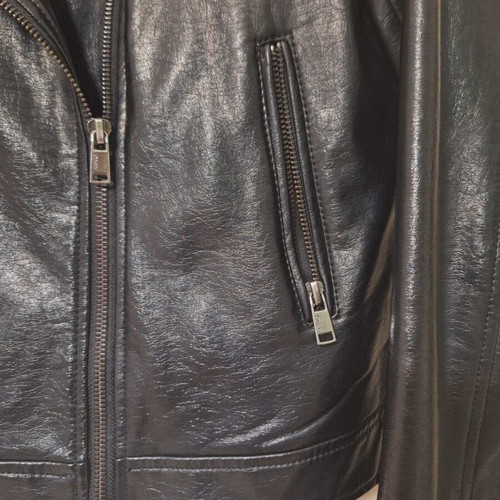 Only black biker jacket made of faux leather with silver details used
