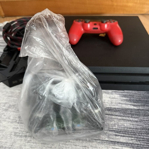 Sony PlayStation 4 Pro 1TB console used with controllers and charging dock