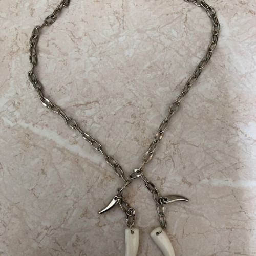 Necklace with plastic and metal fangs