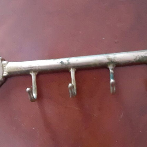 Vintage brass key-shaped hanger used, decorative wall hook