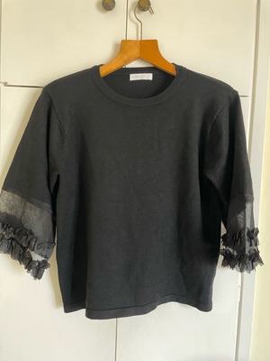 Knitted black blouse like new with transparent sleeve detail