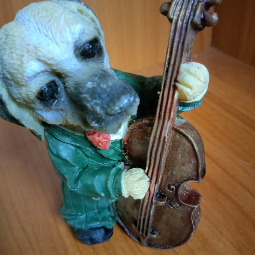 Decorative dog figure with cello like new