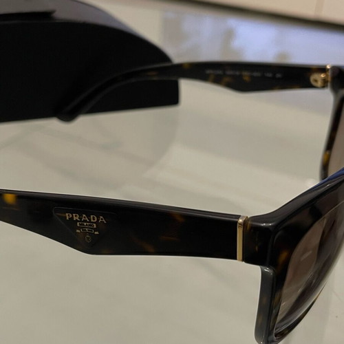Prada SPR 24Q sunglasses used, brown tortoise design with case
