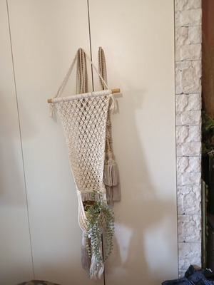 Two knitted wall hangers for pots, different sizes