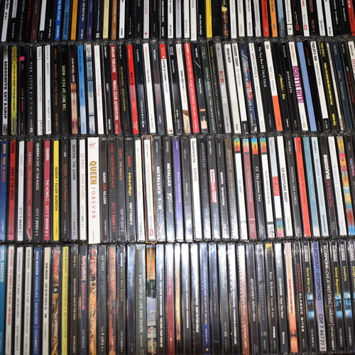 Music collection of 360 rock, pop, metal CDs, 29 music DVDs, 2 VHS tapes, with 2 CD shelves