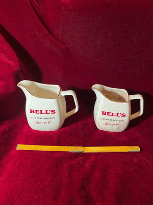 Collectible water jugs used with BELL’S whiskey advertising, pair