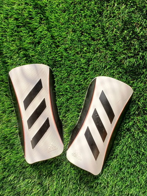 Adidas shin guards used, white and black, lightweight and durable