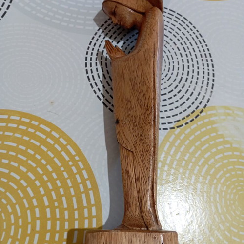 Handmade wooden Madonna statue in praying pose with halo