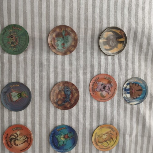Pokemon Tazos used with visible wear