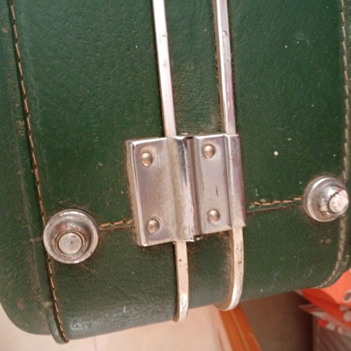 Vintage suitcase used with dark green color and quilted lining