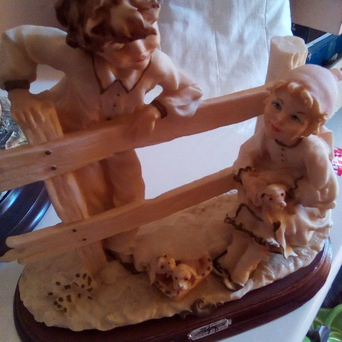 Decorative children with dogs gypsum on wood used