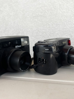 Olympus Super Zoom and Nikon Zoom Touch 600 cameras used