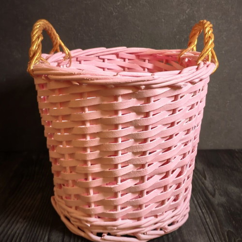 Decorative pink rattan basket with gold handles, handmade