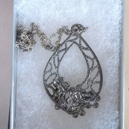 Chain with large motif used, silver with floral decoration