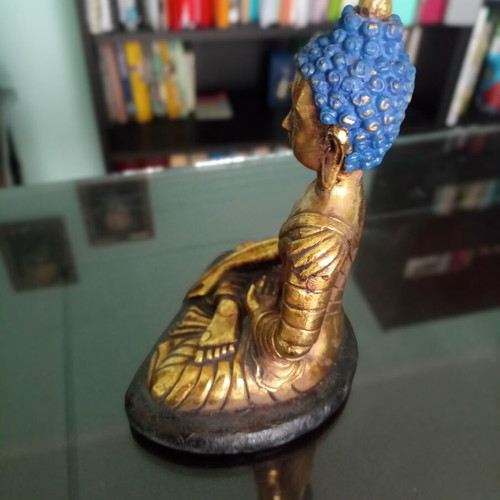 Golden ceramic Buddha statue sitting meditation decoration