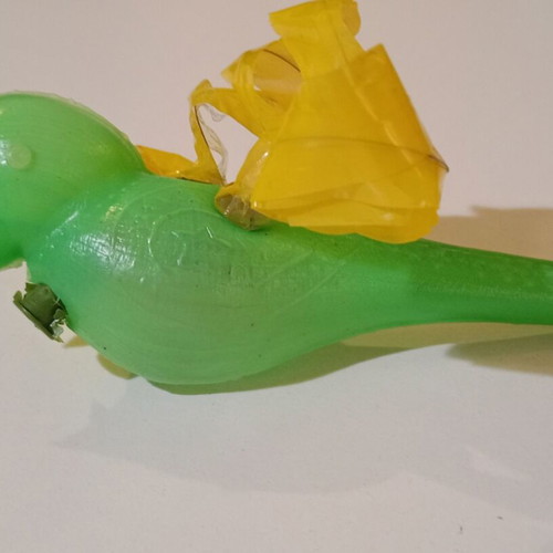 Plastic bird-shaped whistle used, green color