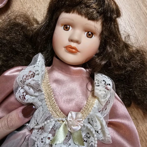 Glass doll like new with satin rotten apple dress and hat