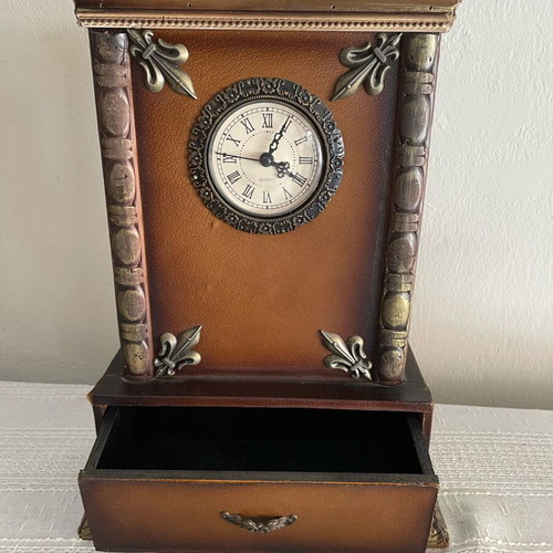 Vintage tabletop clock used with leather finish and brass carved details