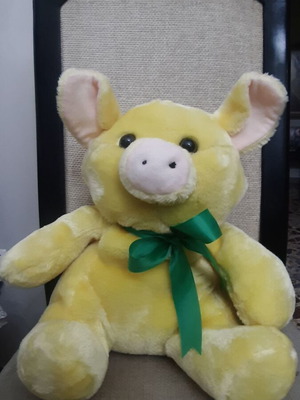 Yellow plush pig with green bow