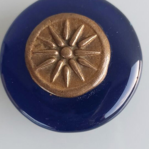 Paperweight made of blown glass with Vergina Sun bronze decoration