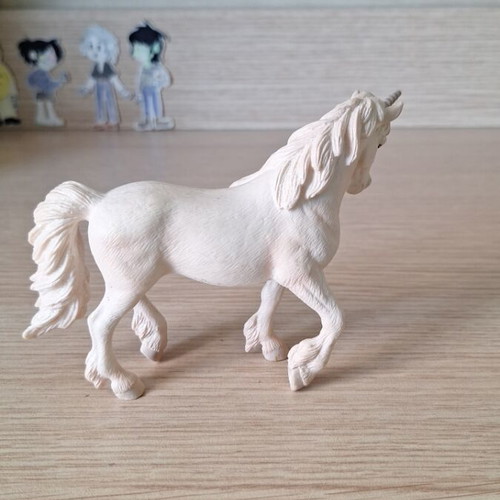 Schleich collectible unicorn figure with pink details and glitter