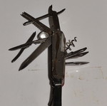 Multitool pocket knife used with red handle and multiple foldable tools
