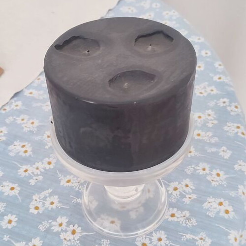 Black candle with transparent glass candlestick used