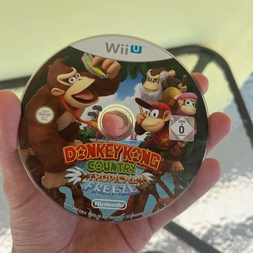 Nintendo Wii U console used with game cartridges and cables