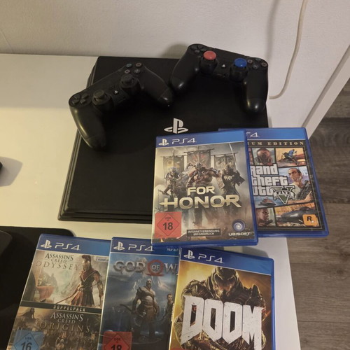 PlayStation 4 1TB like new, 2 consoles with 5 games
