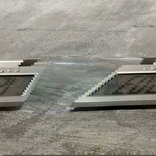 Digital table clock used with alarm and thermometer