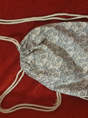 Drawstring backpack with paisley pattern and gold details, new