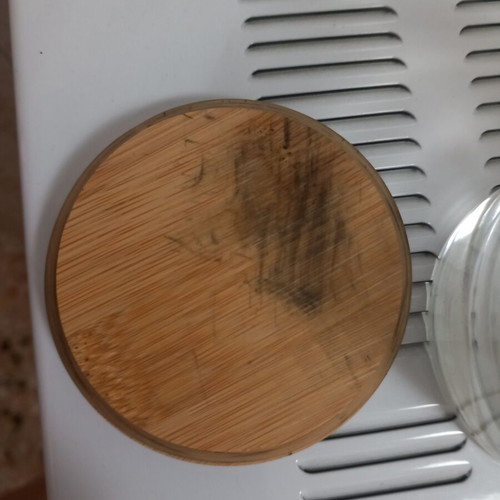 Candle container with wooden lid