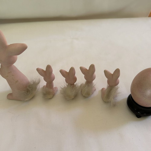 Vintage ceramic pink bunny family figurines with decorative Easter egg