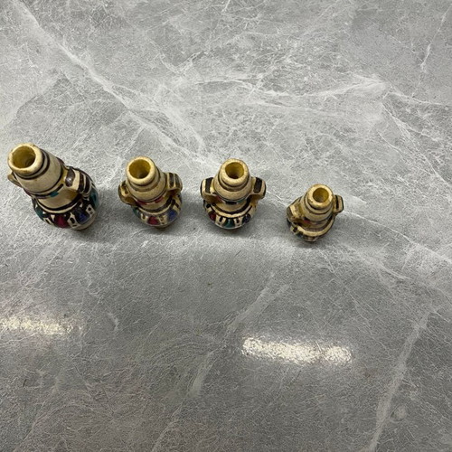 Set of four used vintage hand-painted porcelain vases