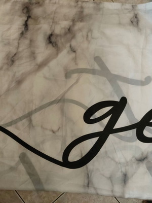 Waterproof shower curtain with marble design and calligraphic logo, like new